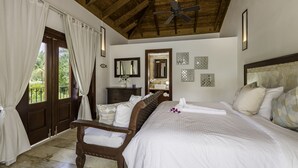 A bedroom with a wooden ceiling, a bed with white bedding, a wooden chair, a dresser, and a mirror. - Luxurious Casa de Campo Villa for up to 12 people (La Romana)