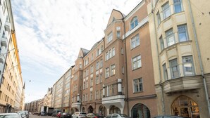 A row of multi-story buildings with a uniform architectural style, featuring large windows and a central entrance. - Cosy Quiet Apartment Close to the Sea and Parks (Helsinki)