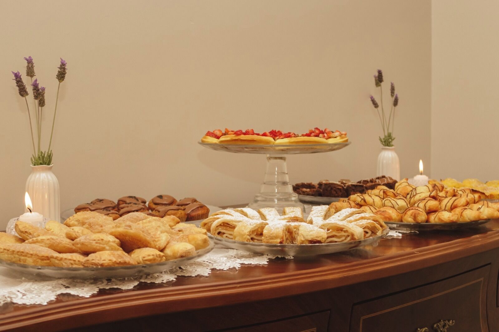 A buffet table with various pastries and desserts.