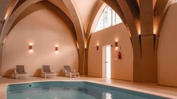 Indoor pool, open 9:00 AM to 10:00 PM, pool loungers