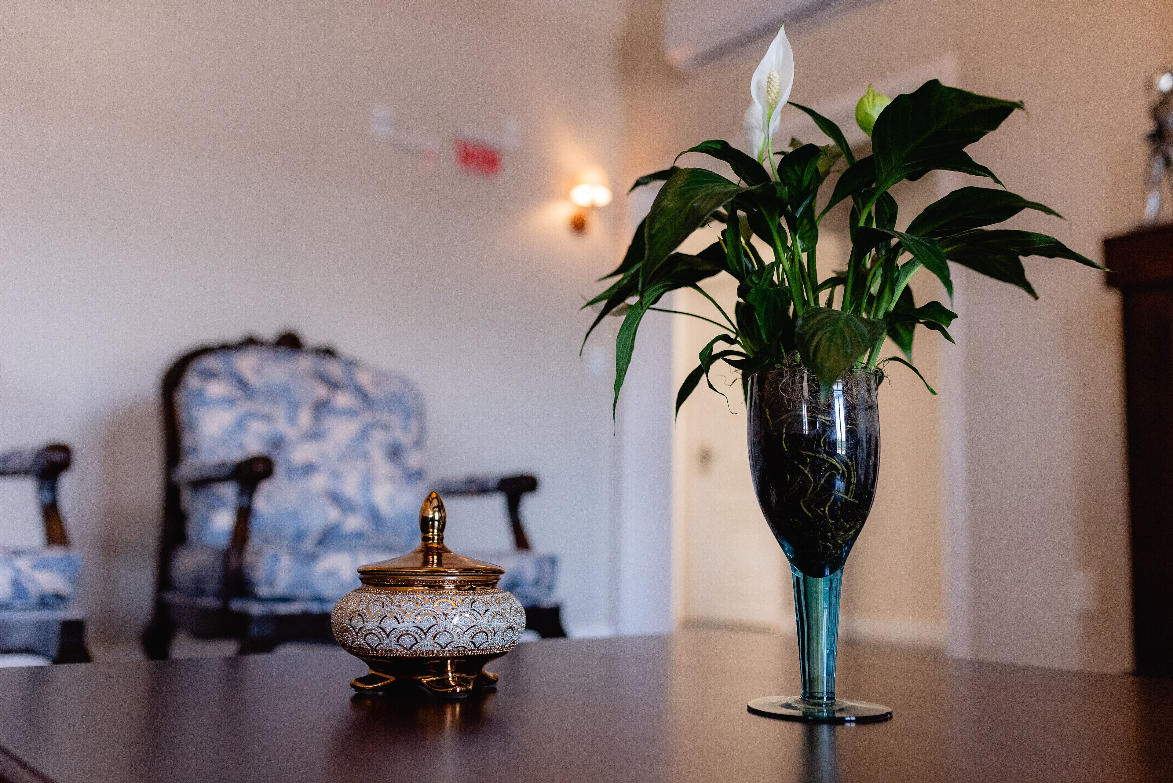A table with a decorative vase and a small ornate container.