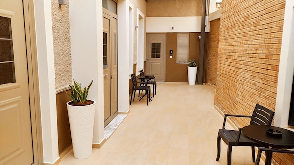 Stroll through the corridor to a cozy dining area with a table and chairs.