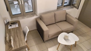 Cozy living space with a sofa, table, and chair, perfect for relaxing.