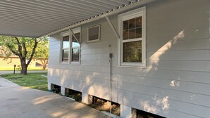 A house with a covered porch, two windows, and a brick foundation. - CUTE & QUIET FAMILY HOUSE (Denham Springs)