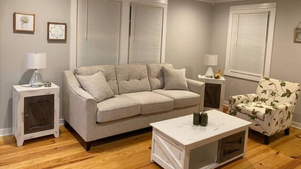 A living room with a sofa, a coffee table, and two side tables. - CUTE & QUIET FAMILY HOUSE (Denham Springs)