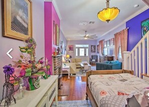 Relax in this inviting space with a comfortable bed, sofa, and dining area.