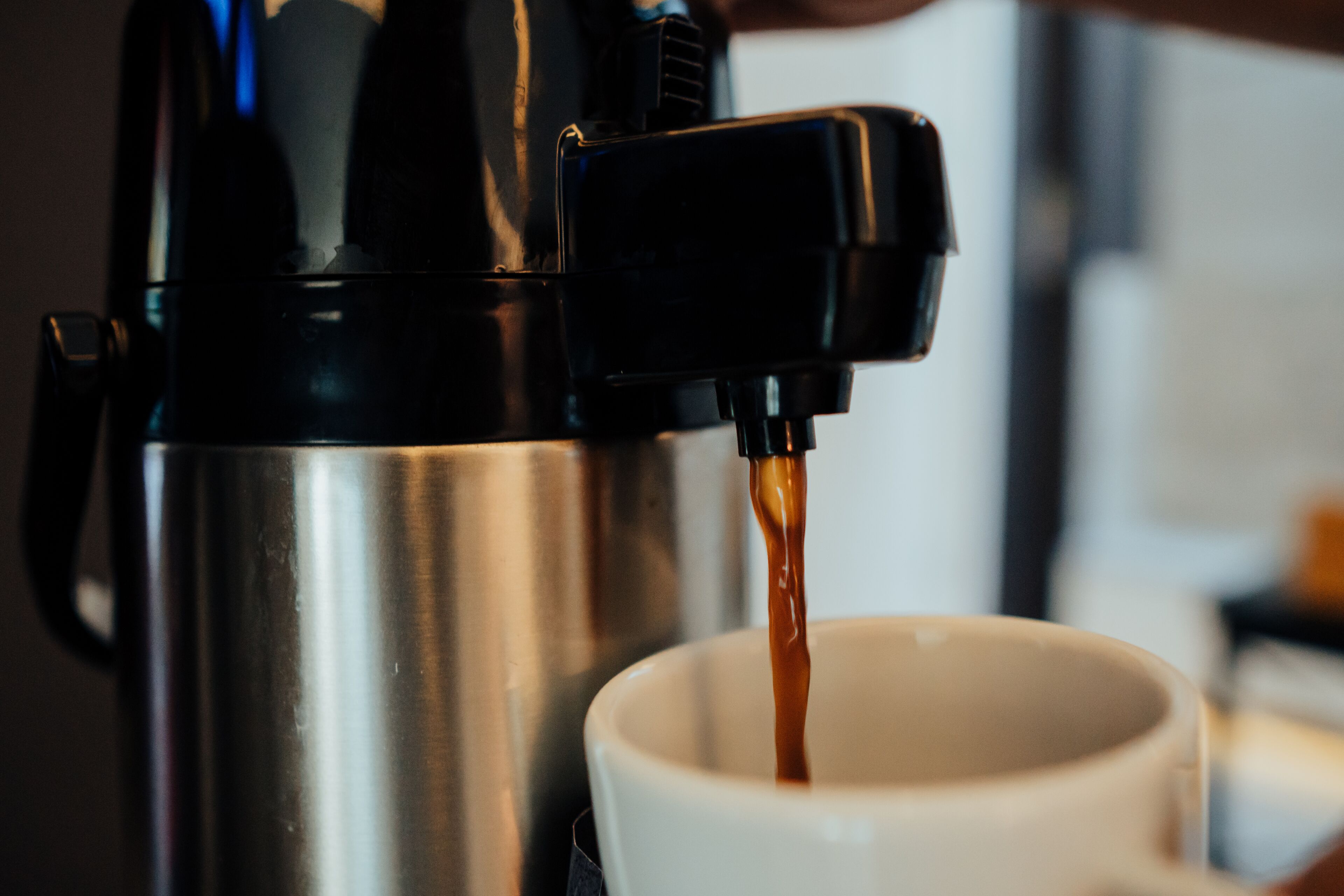 A coffee machine dispensing coffee into a cup.