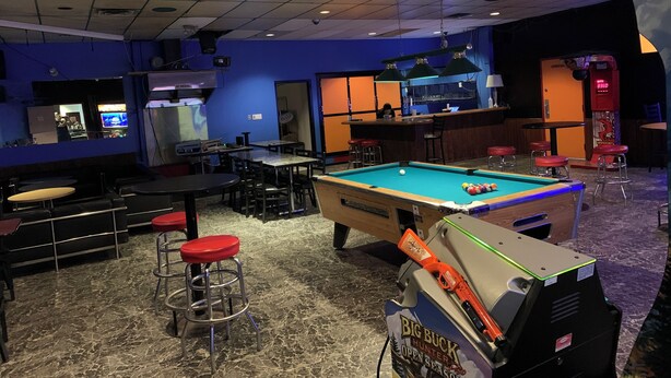 A billiards room with tables, stools, and a pool table. - Whitewood Inn (Whitewood)