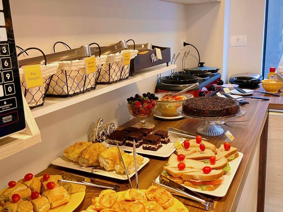 A buffet with various food items including bread, pastries, and desserts.