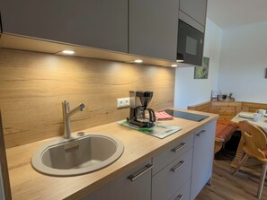 Fridge, microwave, stovetop, coffee/tea maker