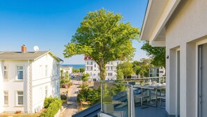 A residential building with a balcony, a tree, and a view of other buildings. - Domicile Düne 8, App. 7 (Heringsdorf)