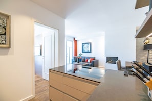 A modern kitchen with a central island, a dining area with a table and chairs, and a living room with a sofa and a coffee table. - Beachhouse Bansin, App. 25 (Heringsdorf)