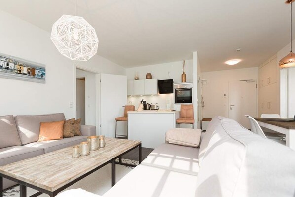 Un apartamento moderno con sala de estar, cocina y comedor.