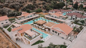 A modern resort with a central swimming pool, multiple guest villas, and a landscaped garden. - The Pearl Ölüdeniz (Fethiye)
