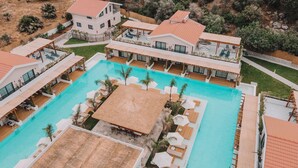 A resort with a central swimming pool, multiple guest rooms, and outdoor seating areas. - The Pearl Ölüdeniz (Fethiye)