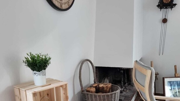 A cozy living room with a fireplace, wooden furniture, and decorative baskets. - Large family house, large garden in an oyster site close to the beach (La perrotine)