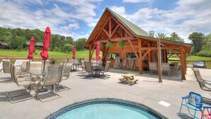 A wooden pavilion with a pool and outdoor seating. - Bears Valley #171 (Sevierville)