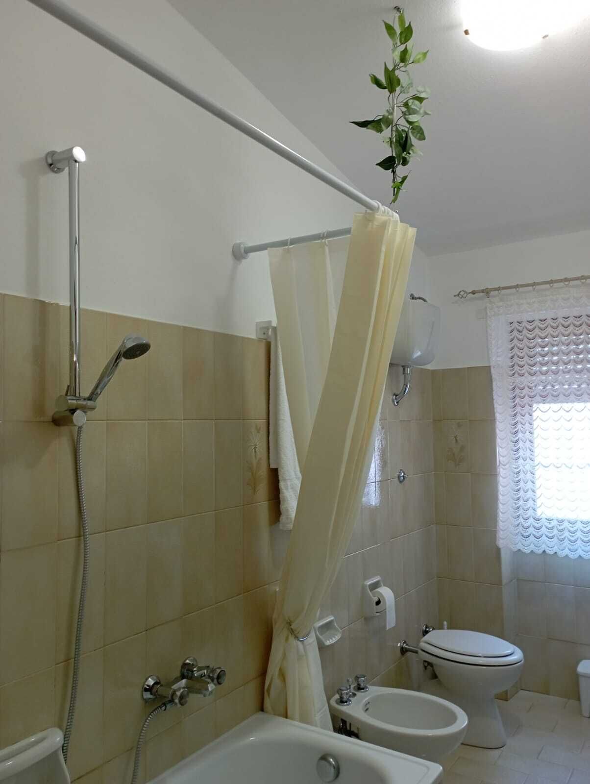Une salle de bain équipée d’une douche, de toilettes, d’un bidet et d’une baignoire.