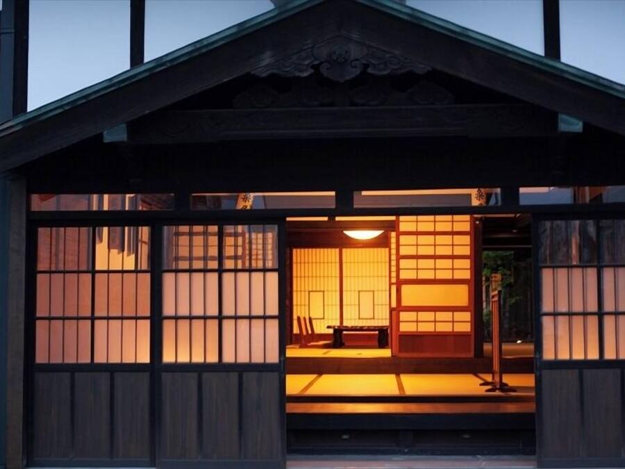 A traditional Japanese-style building with tatami mat flooring and sliding doors.