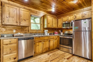 Enjoy cooking in this well-equipped kitchen with a dishwasher, oven, refrigerator, microwave, and coffee maker.