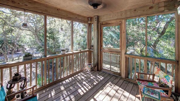 A wooden deck with a railing, large windows, and a ceiling fan. - Charlotte's Place - Ocracoke Island (Ocracoke)
