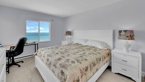 A bedroom with a bed, a desk, and a nightstand. - BEACHFRONT ON A BUDGET!  MILLION $ VIEW!  2B/2B ISLAND VACATION CONDO! (Fort Myers Beach)