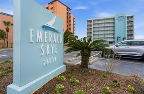 A hotel sign with the name 'Emerald Sky' and the number '26034'. - Emerald Skye 11- Your Beach Trip is Calling. Book Today! (Orange Beach)