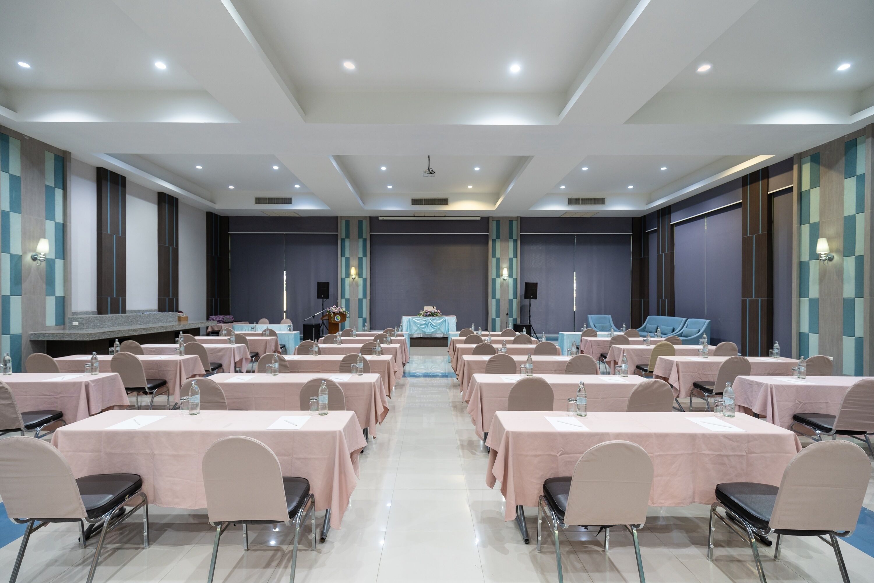 A conference room with tables and chairs arranged for a meeting.
