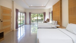 A hotel room with two beds, a sliding glass door to the outside, and a wooden wardrobe. - Thara Cholapruek Resort (Ban Na)