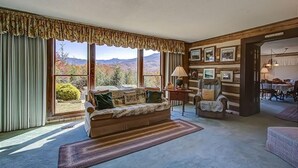 A cozy living room with a large window, a sofa, a chair, and a rug. - Far Horizons #416 (Gatlinburg)