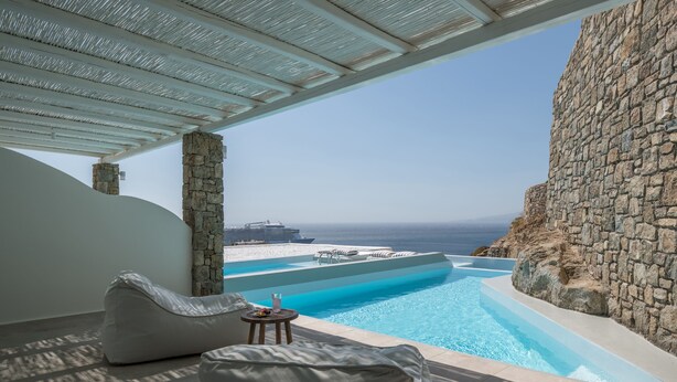 A modern infinity pool with a clear view of the ocean and a distant cruise ship. - Arocaria (Mykonos)