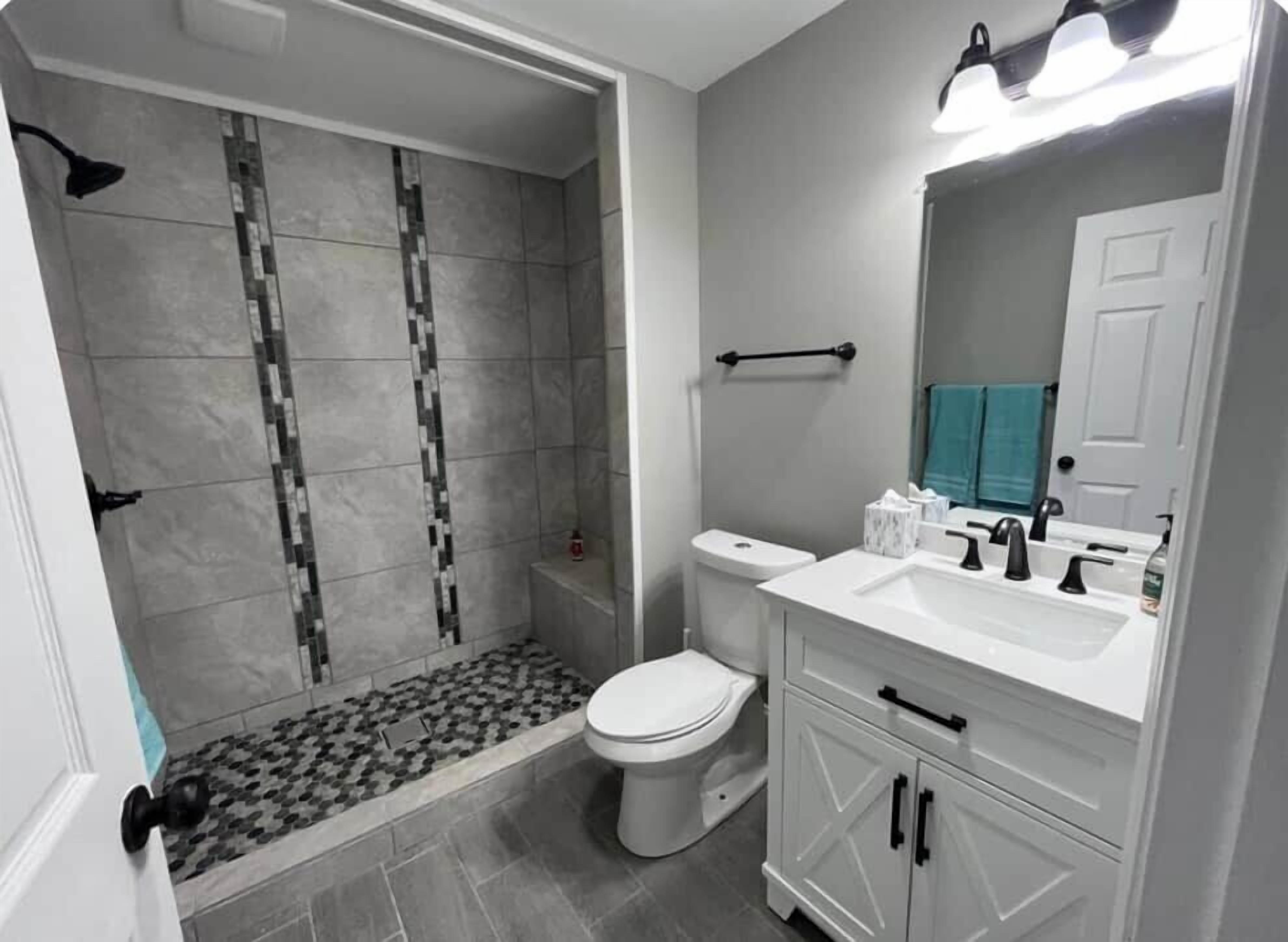 Combined shower/bathtub, towels, soap, toilet paper