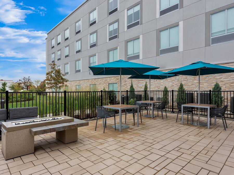 An outdoor patio with seating, tables, and umbrellas.