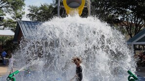 A water play area with a large fountain and two green water jets.