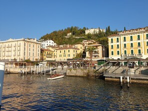 A waterfront hotel with a view of the water and surrounding buildings.