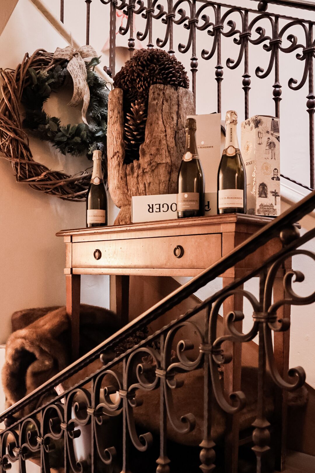 A wooden chest of drawers with a sign reading "DOKTER" on a staircase with ornate metal railings.