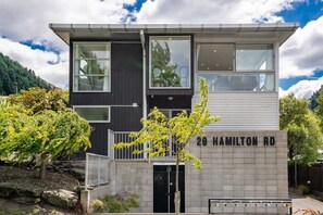 A modern two-story house with a balcony, a stone facade, and a sign indicating '29 Hamilton Rd.' - Central Queenstown Luxury (Queenstown)