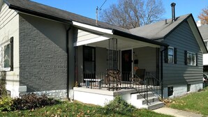 A two-story house with a covered porch, a brick exterior, and a chimney. - Beautiful Home in South Park. Walk to UD Campus, Miami Valley Hospital, Downtown (Dayton)