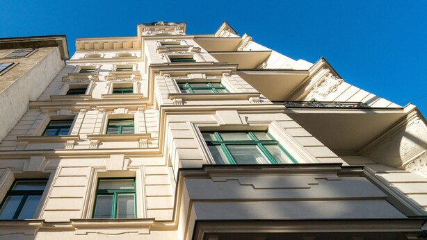 A multi-story building with classical architectural details, including ornate window frames and decorative moldings. - Vienna Residence, City Hall - Parliament #6415 (Vienna)