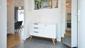A modern kitchen with white cabinets, a dining area with a table and chairs, and a large window. - Vienna Residence, Donaust.- United Nations #6251 (Vienna)