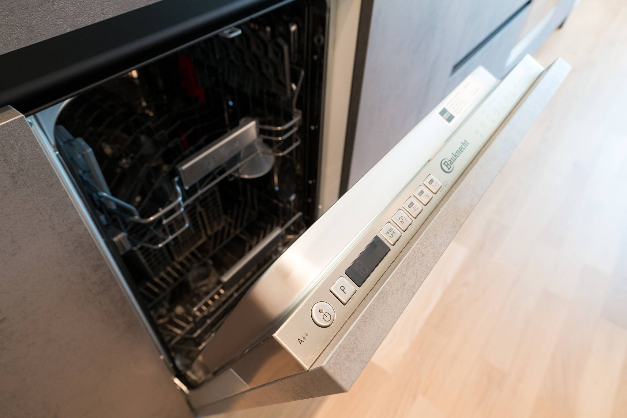 A dishwasher with a digital display and control panel.