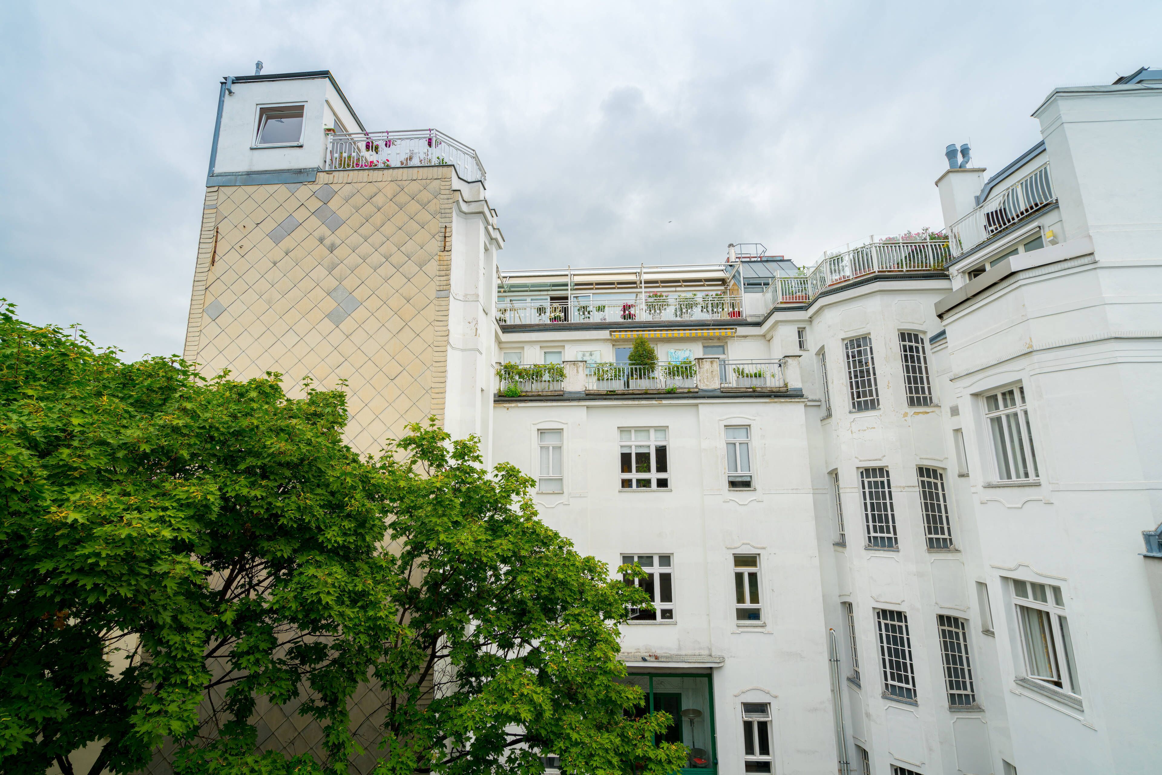 A multi-story building with balconies and windows.