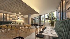 A modern restaurant with a long dining table, multiple chairs, and a view of the outdoors. - Residence Inn by Marriott Paris Charles de Gaulle Airport (Roissy-en-France)