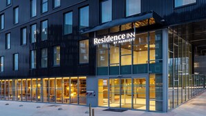 A modern hotel exterior with large glass windows and a sign reading "Residence Inn by Marriott". - Residence Inn by Marriott Paris Charles de Gaulle Airport (Roissy-en-France)