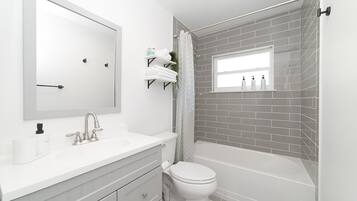 Combined shower/tub, hair dryer, towels, soap
