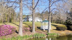 A serene landscape with a pond, trees, and a gazebo. - Charming 1892 Log Cabin in the Blue Ridge Mountains foothills (Rutherfordton)
