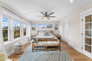Enjoy a comfortable stay in this room with a large bed, nightstands, and a window offering a neighborhood view.