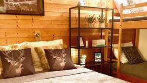 A wooden room with a bunk bed, a desk, and a bookshelf. - Spacious and clean appart. (4-6 pers.) on piste at Altispace, very centrally located (Valmorel)