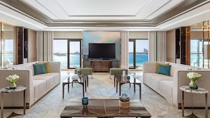 A spacious living room with a large flat-screen TV, comfortable seating, and a view of the sea. - Taj Exotica Resort & Spa, The Palm, Dubai (Dubai)