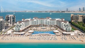 A hotel with a pool, beach, and ocean view. - Taj Exotica Resort & Spa, The Palm, Dubai (Dubai)